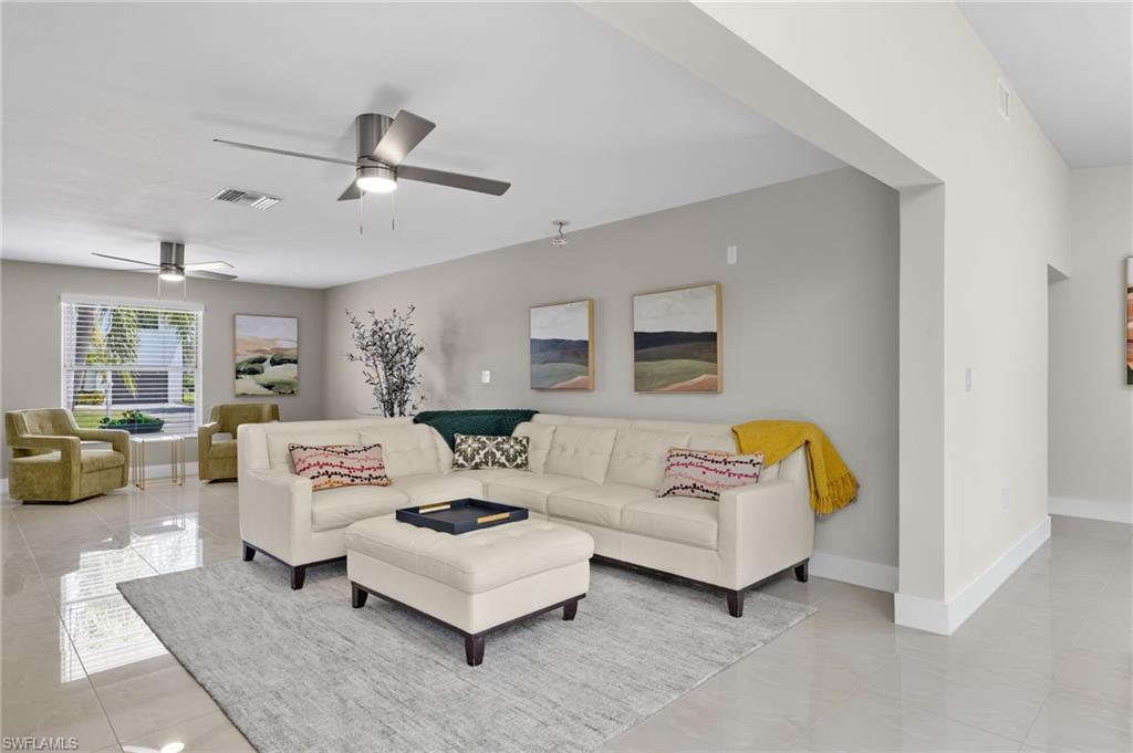 Tiled living room featuring ceiling fan