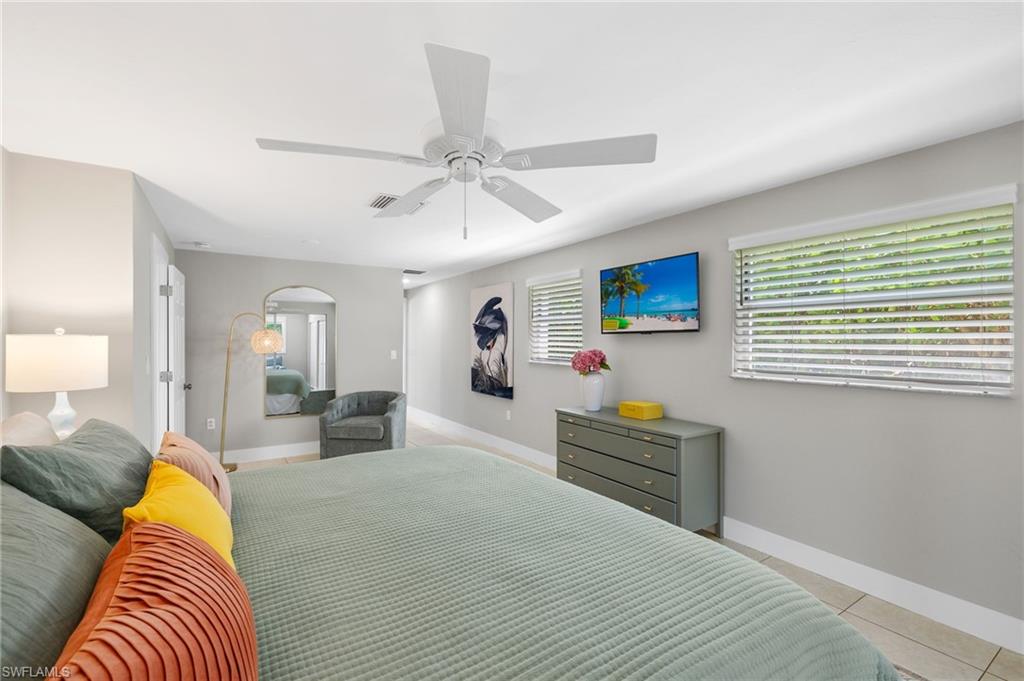 Tiled bedroom with ceiling fan
