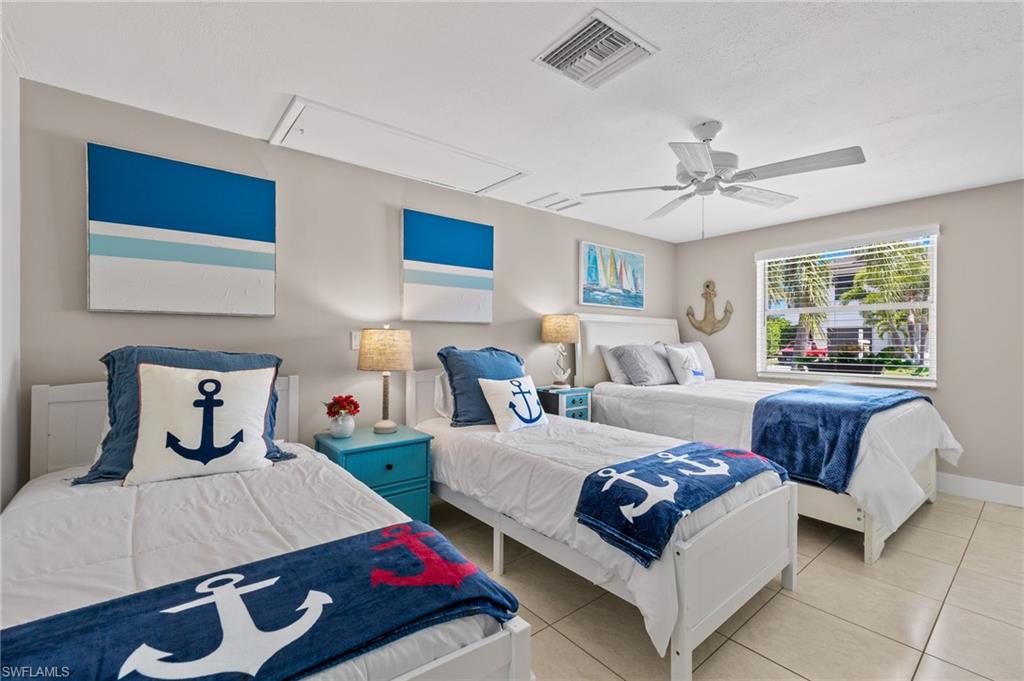 Tiled bedroom with ceiling fan