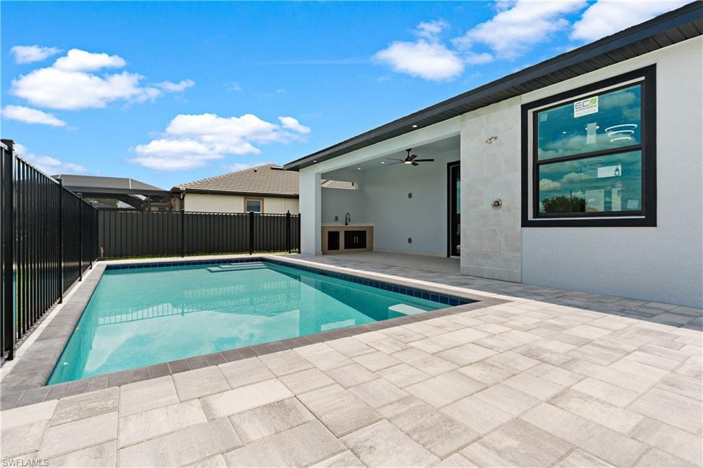 Rectangular swimming pool surrounded by paver decking