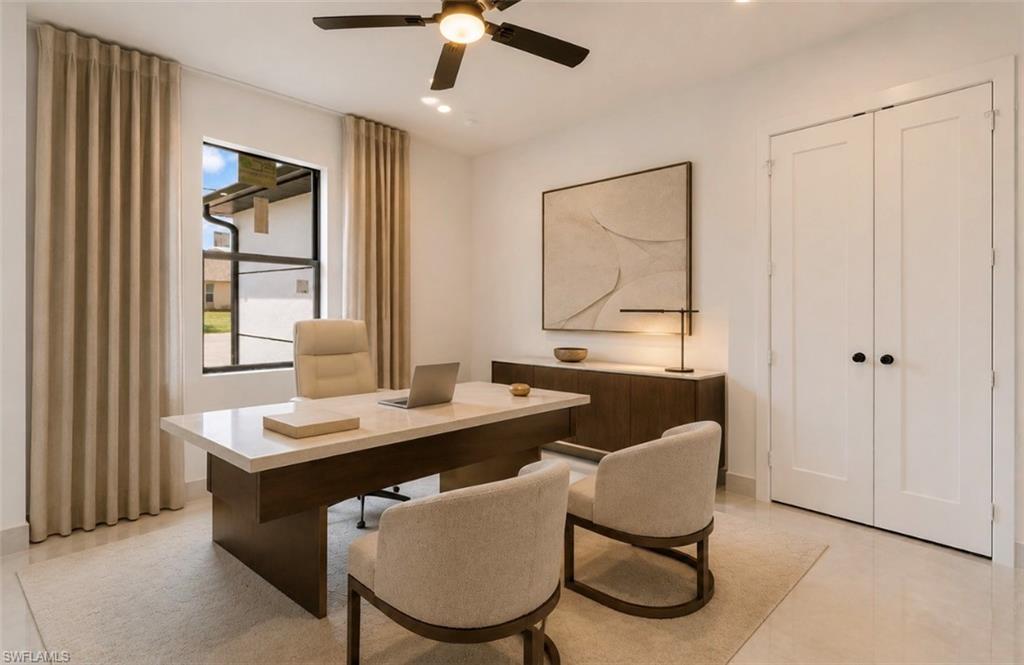 White interior walls with recessed lighting and a ceiling fan