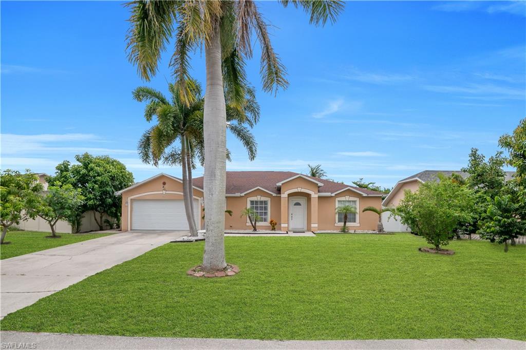 Single-story residence featuring a two-car garage, concrete driveway, and a covered entry