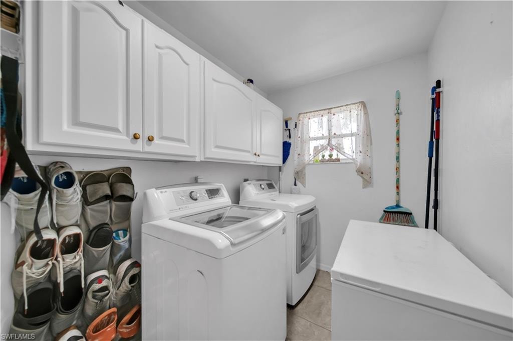White shaker-style cabinetry, recessed ceiling lighting, and tiled flooring