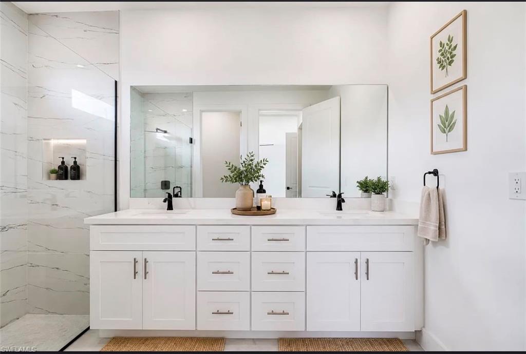 Dual sink vanity with white cabinetry and quartz countertop