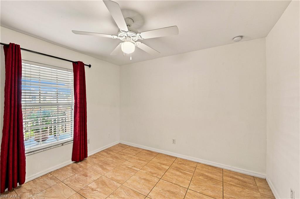 Recessed lighting, ceiling fan with integrated lighting, window with blinds, and tile flooring