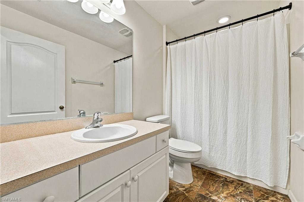Vanity with an integrated sink, polished chrome faucet, and ample storage cabinetry