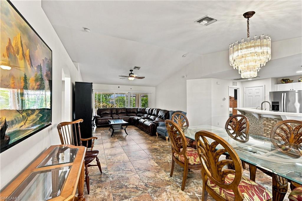 Vaulted ceilings enhance the main living areas, complemented by tiled flooring throughout