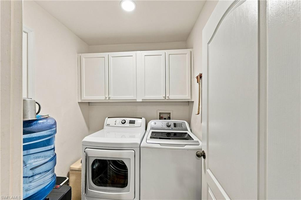 Laundry area with overhead white shaker-style cabinetry and recessed lighting