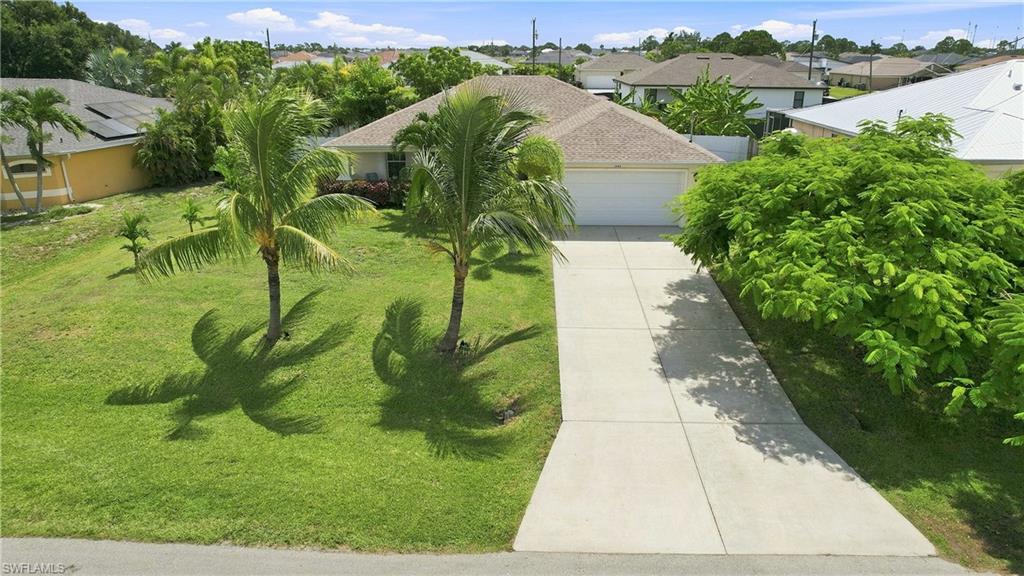 Single-story residence featuring a two-car garage, concrete driveway, and a shingle roof