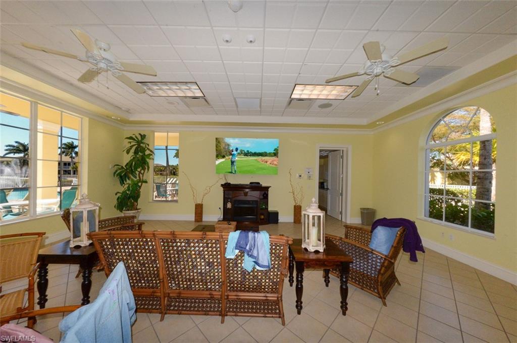 Social gathering room features table and chairs for meetings, parties and card games, TV and a lounging area.