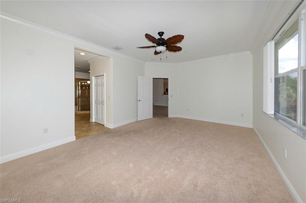 Primary suite looking toward great room and private luxury bathroom to left