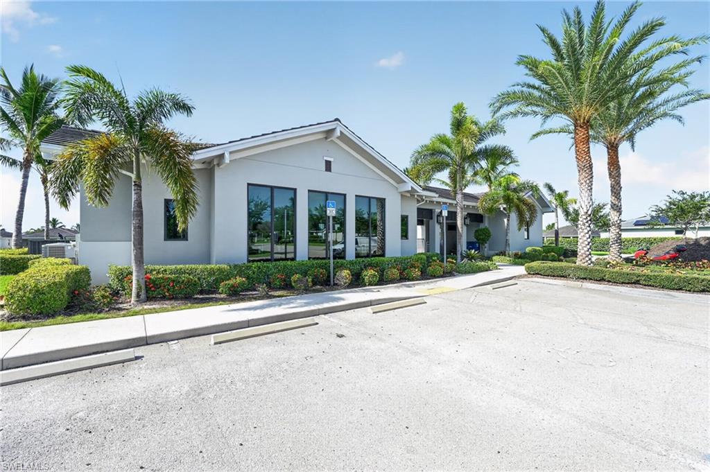 Modern white exterior with gabled roofline and large multi-pane glass doors opening to the front elevation