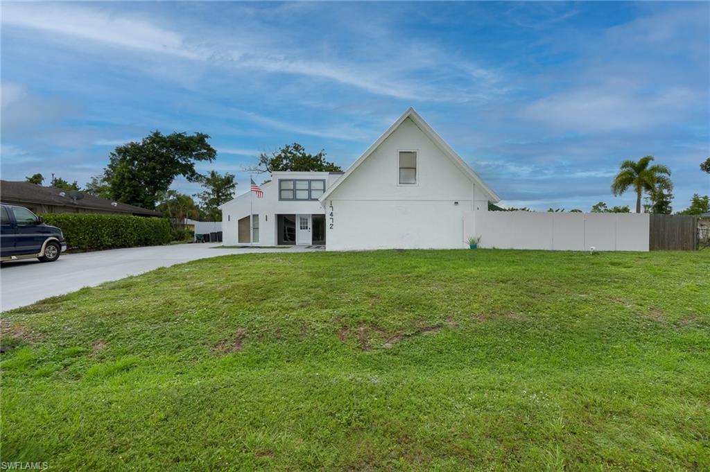 Contemporary exterior with a white finish, featuring a prominent gable roofline and a large, flat-panel window section