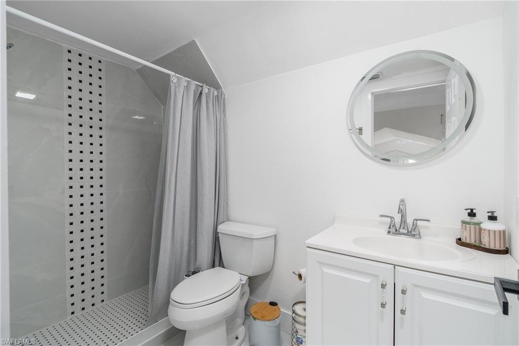 Walk-in shower with tile surround and decorative mosaic accents