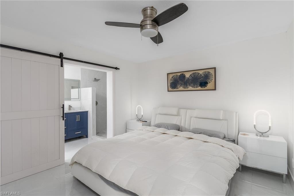 White walls complement the polished tile flooring and ceiling fan with integrated lighting