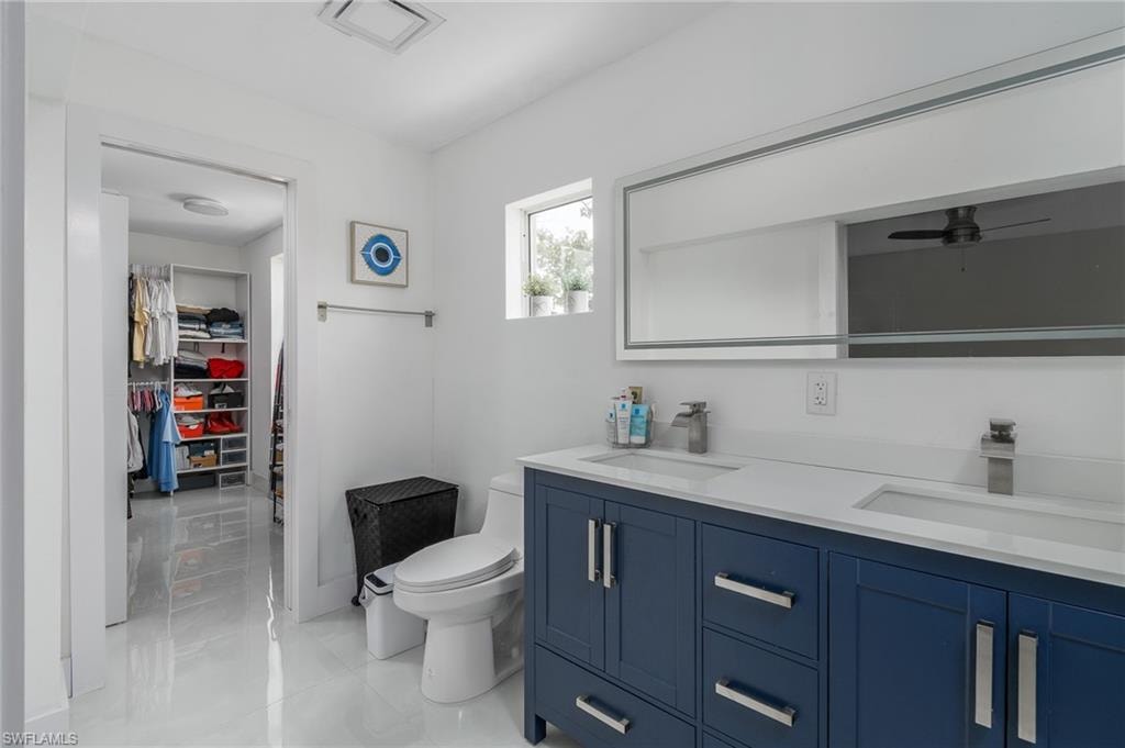 Double vanity with blue cabinetry and white countertop