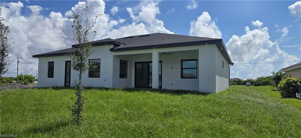 White stucco exterior with a dark roof