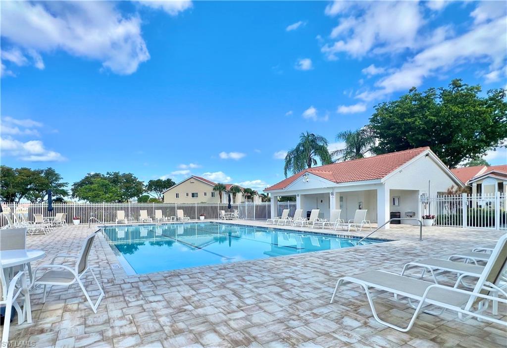 Community pool featuring fence and a patio area