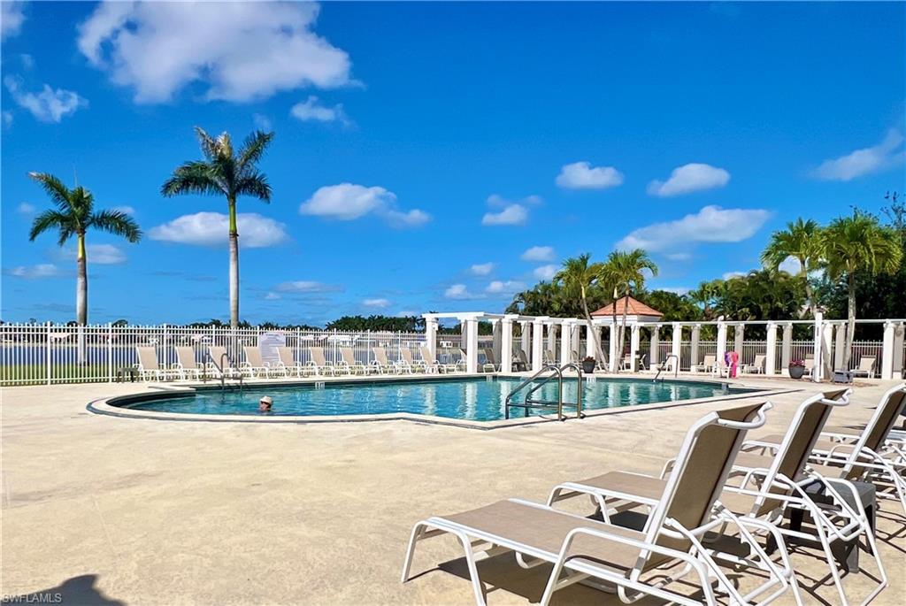 Community pool with fence and a patio area