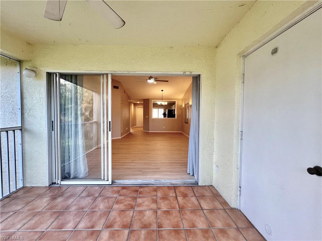 Lanai Entrance to property with stucco siding and a ceiling fan