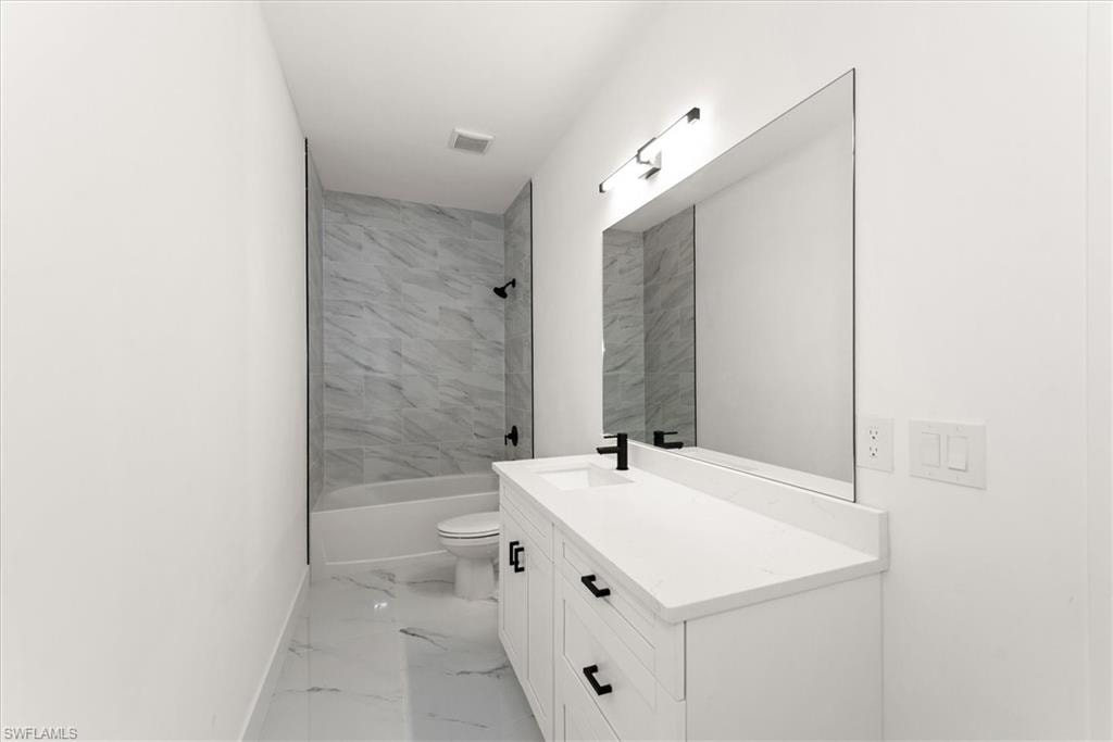 Guest bathroom is huge measuring 15 foot long! It also has a door leading to the back lanai which makes it a great future pool bath.