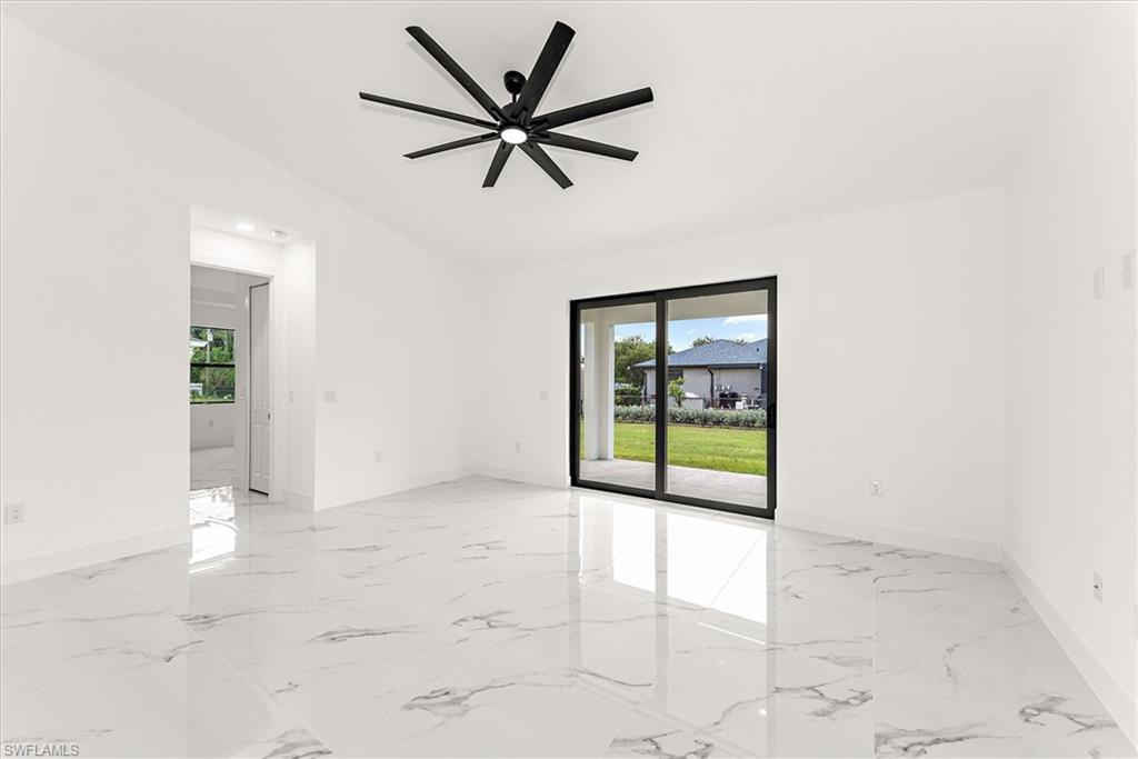 Family room area with vaulted ceilings reaching 13 foot. 32" tile throughout make this home flow very well.