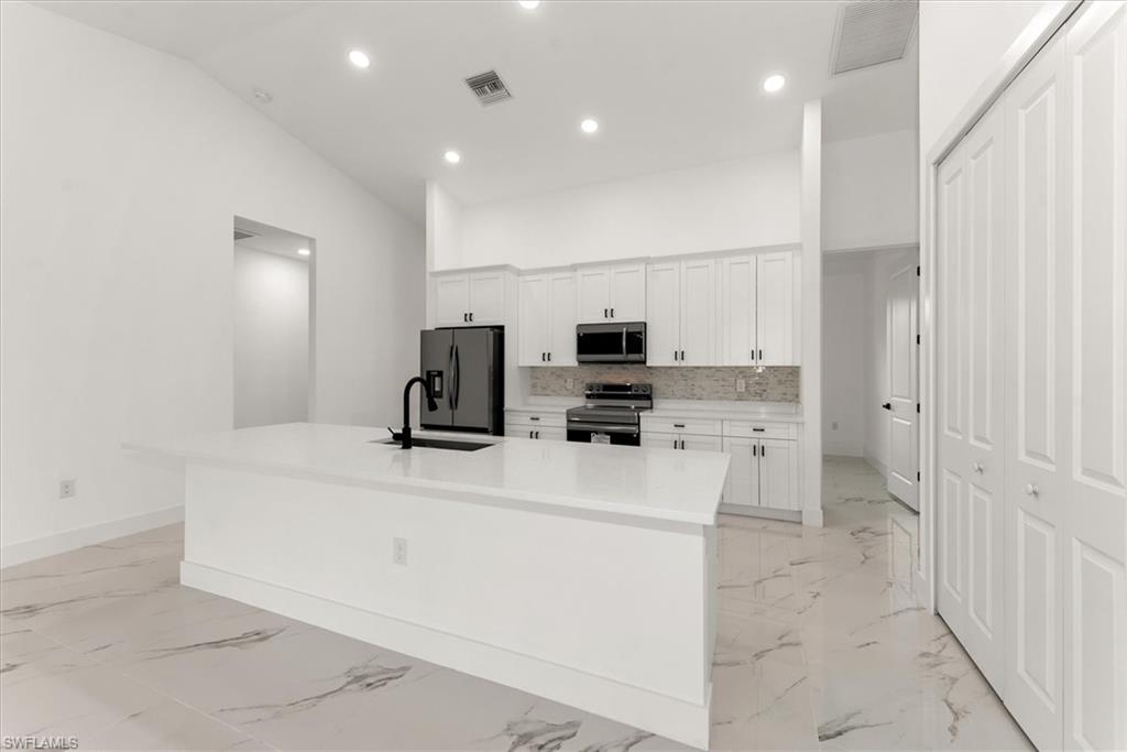Wow the kitchen looks amazing. Behind the kitchen wall is a large flex room that could be used as a formal dining area, a great office, or media room.
