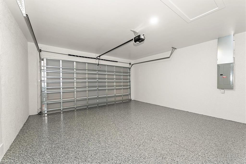 The garage offers added ceiling height with epoxy coated floors.