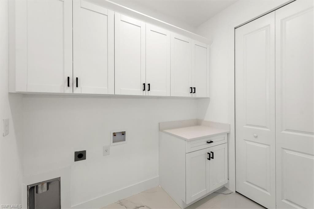 Large laundry room just off the kitchen offers more cabinet storage and a another closet on the right which could give you even more pantry storage.