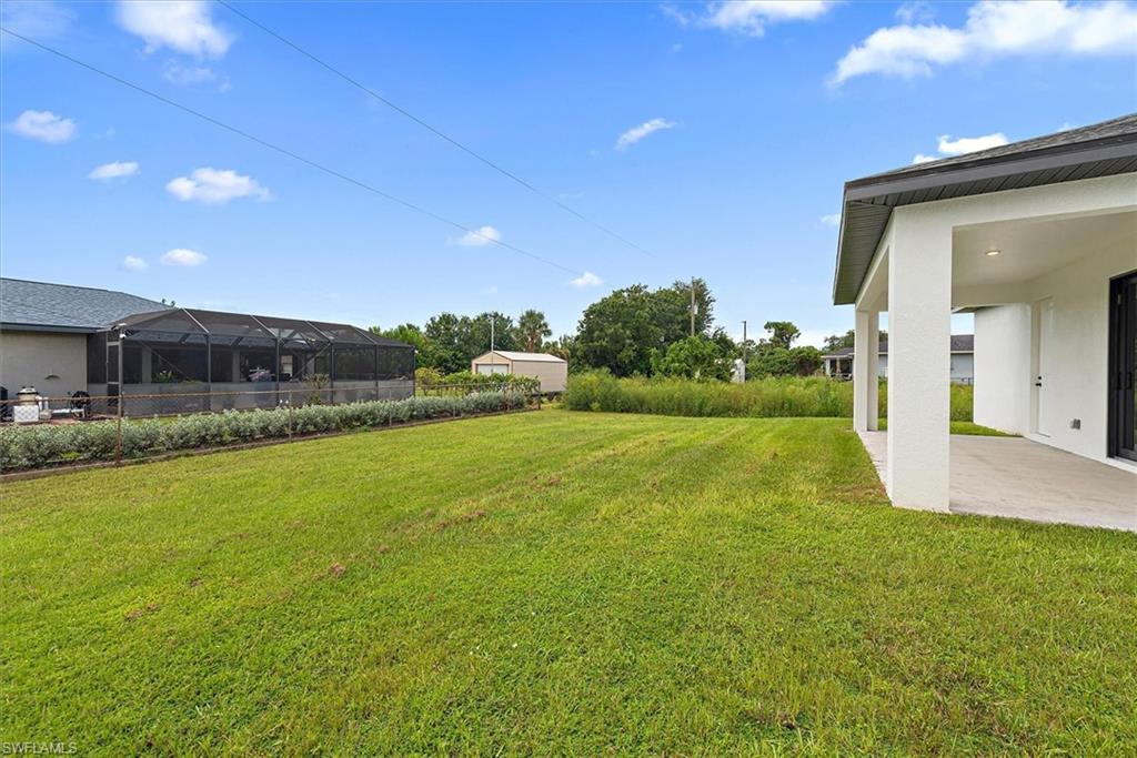 Back yard view. The neighbor behind just planted a nice privacy hedge along the back of their fence line which will give you added privacy as they grow larger.