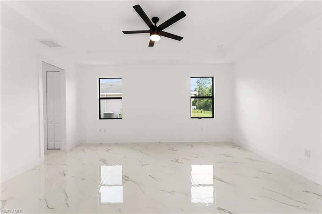 This view is of the primary bedroom. It features a tray ceiling reaching 10'