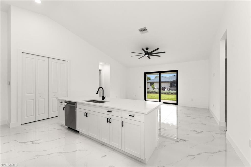 This is the view from the kitchen looking toward the back lanai. The kitchen island is over 10 foot long giving you lots of room to set up bar seating.