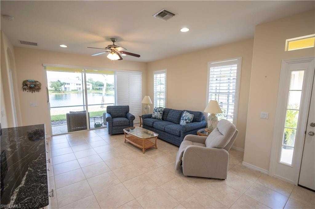 Tile flooring, recessed lighting, ceiling fan, sliding glass door, and plantation shutters