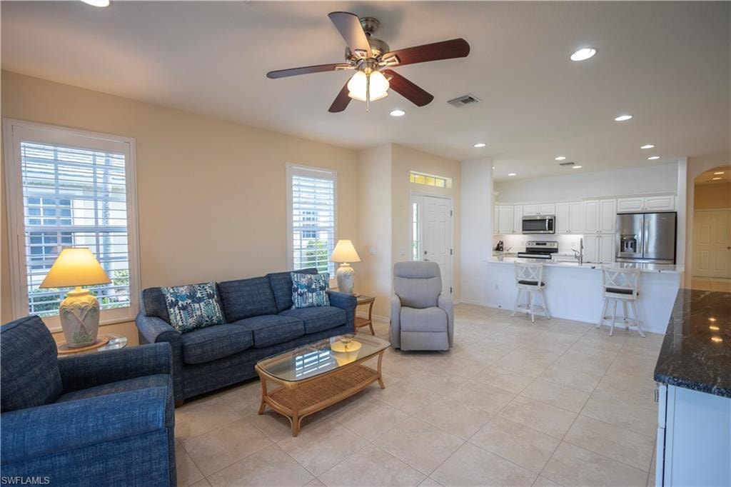 Recessed lighting, ceiling fan, plantation shutters, tile flooring, and a kitchen featuring stainless steel appliances