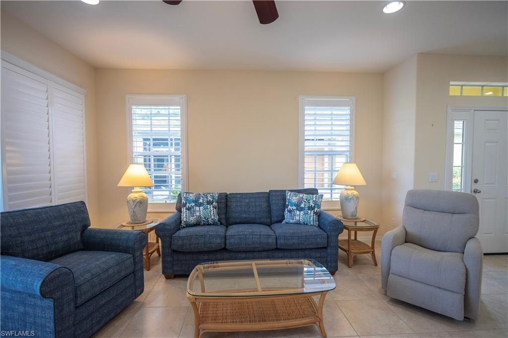 Recessed ceiling lighting, ceiling fan, transom window, white interior door, and tiled flooring