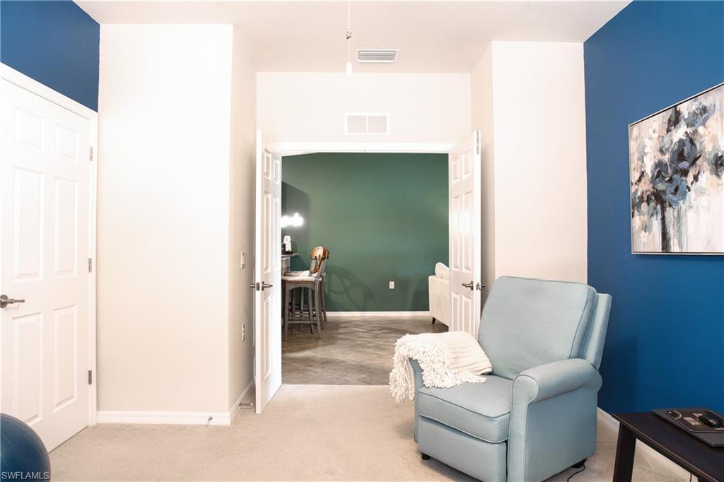 White paneled doors, light carpet flooring, and colorful accent walls
