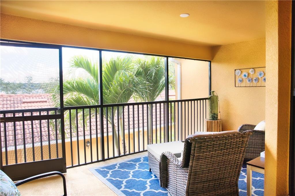 Screened balcony with textured walls, recessed lighting, and tiled roofline scenery