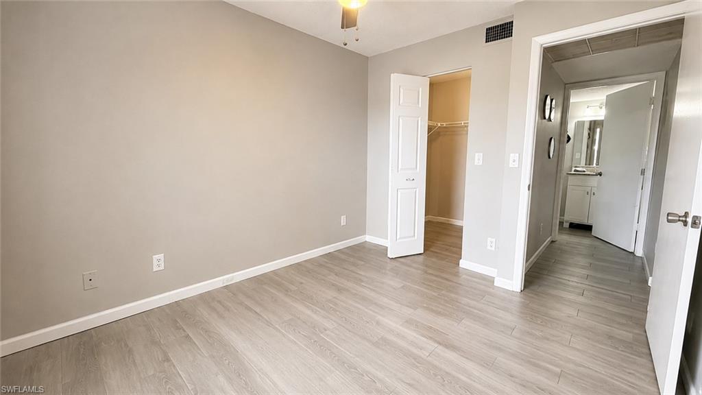 Neutral wall color, wood-finish flooring, ceiling fan, bi-fold closet doors, built-in shelving