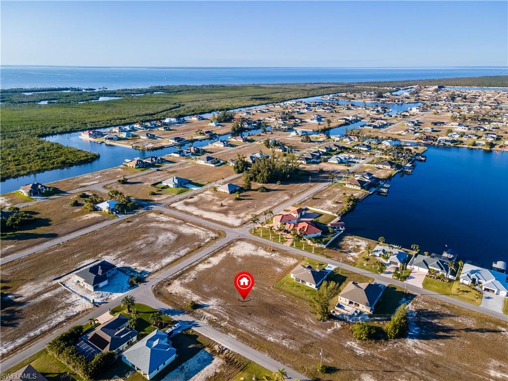 Birds eye view of property with a water view