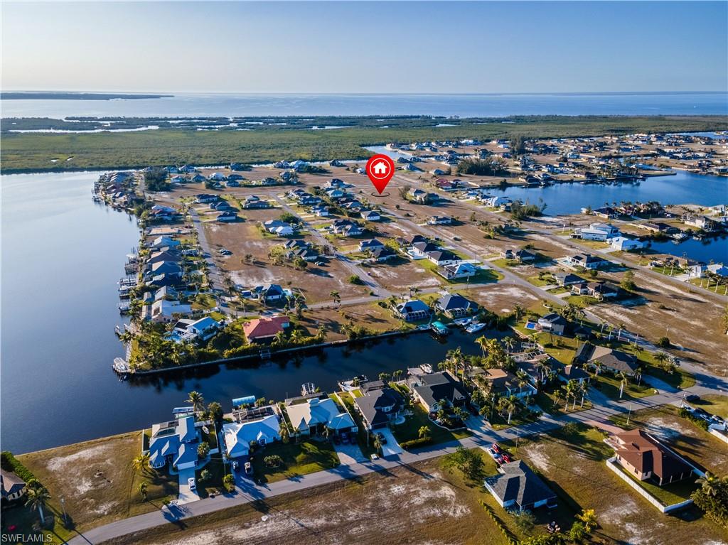 Birds eye view of property with a water view