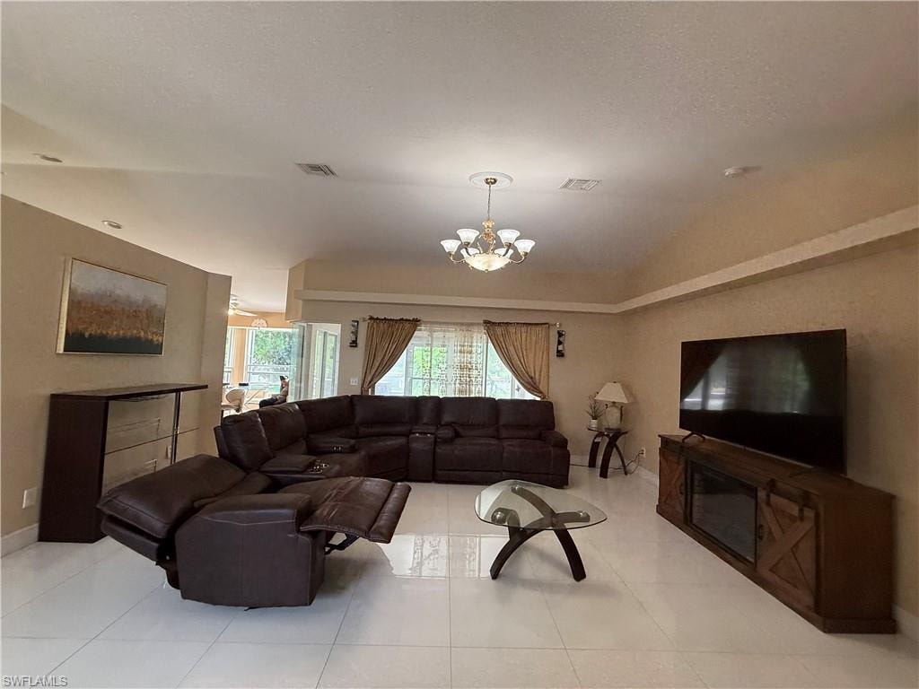 Recessed ceiling, tray ceiling, tile flooring, glass French doors, chandelier