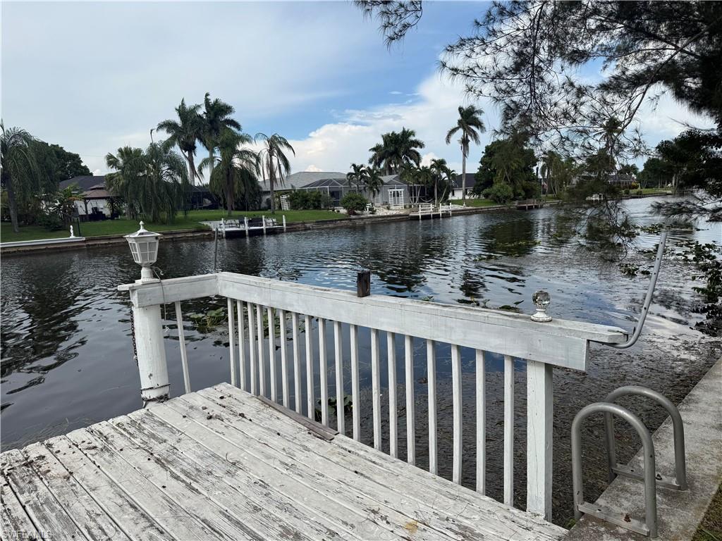 Wooden dock with integrated railing and a metal ladder for water access