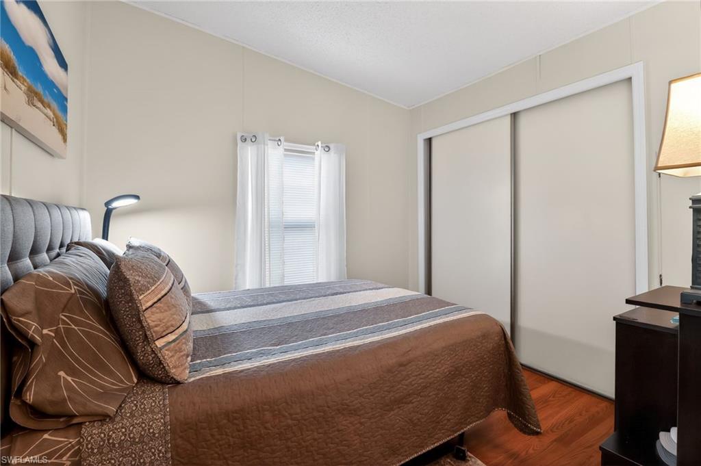 Bedroom featuring warm neutral wall tones and wood-finish flooring