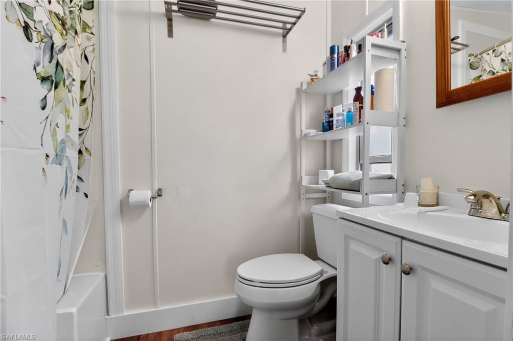Bathroom vanity featuring a white countertop with integrated sink and a chrome faucet