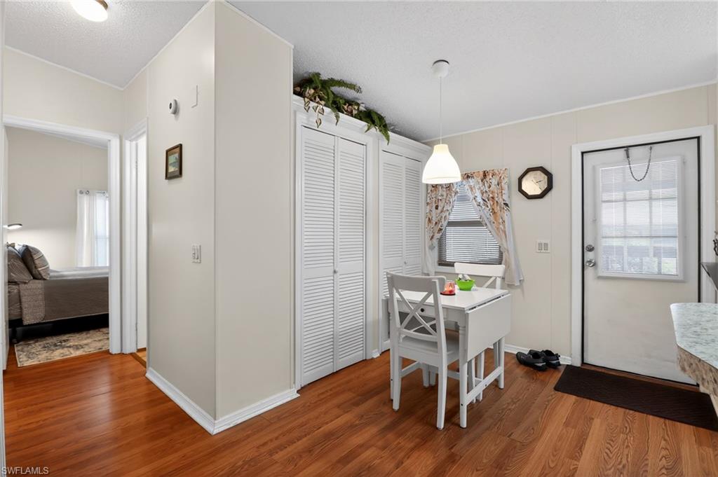 Wood-finish flooring extending from the hallway into the kitchen area