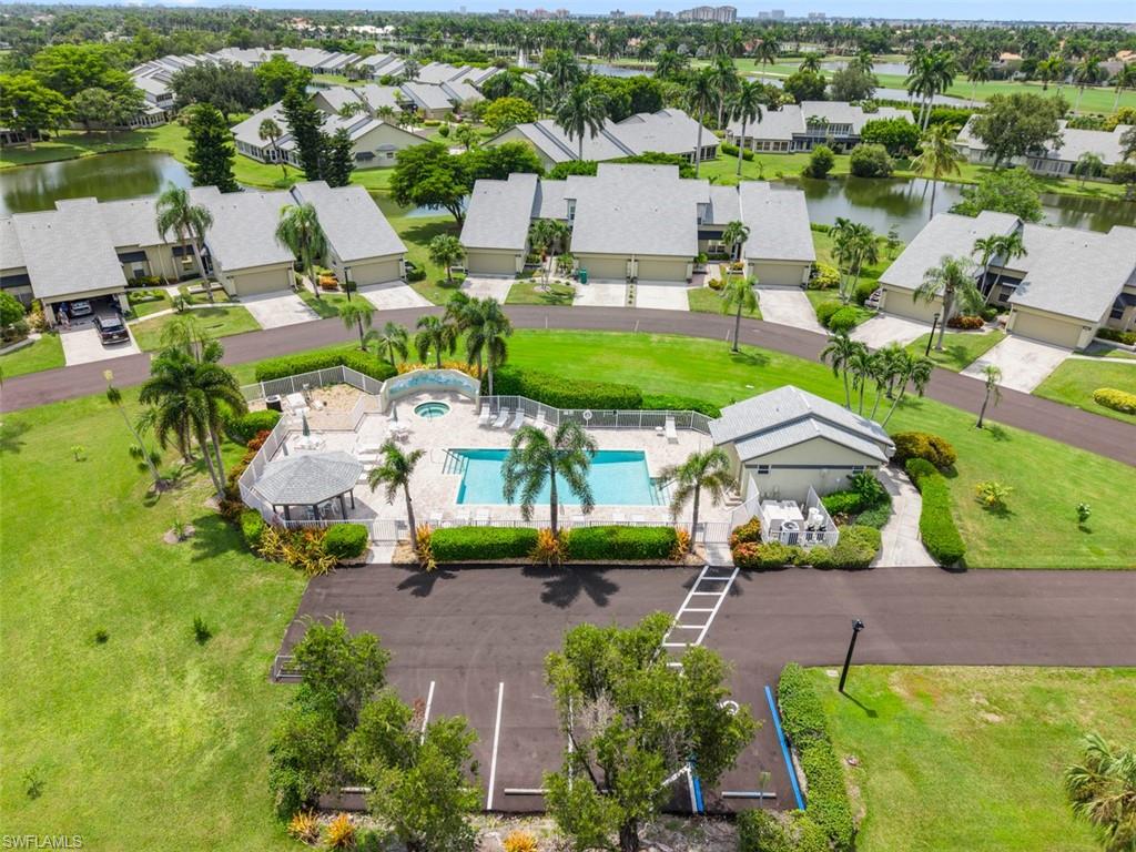 Community swimming pool with surrounding deck, integrated spa, and adjacent covered gazebo