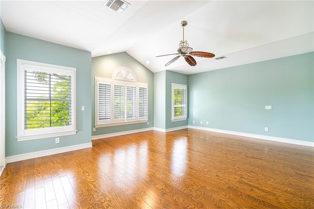 Vaulted ceiling, wood-finish flooring, ceiling fan, transom window, and plantation shutters