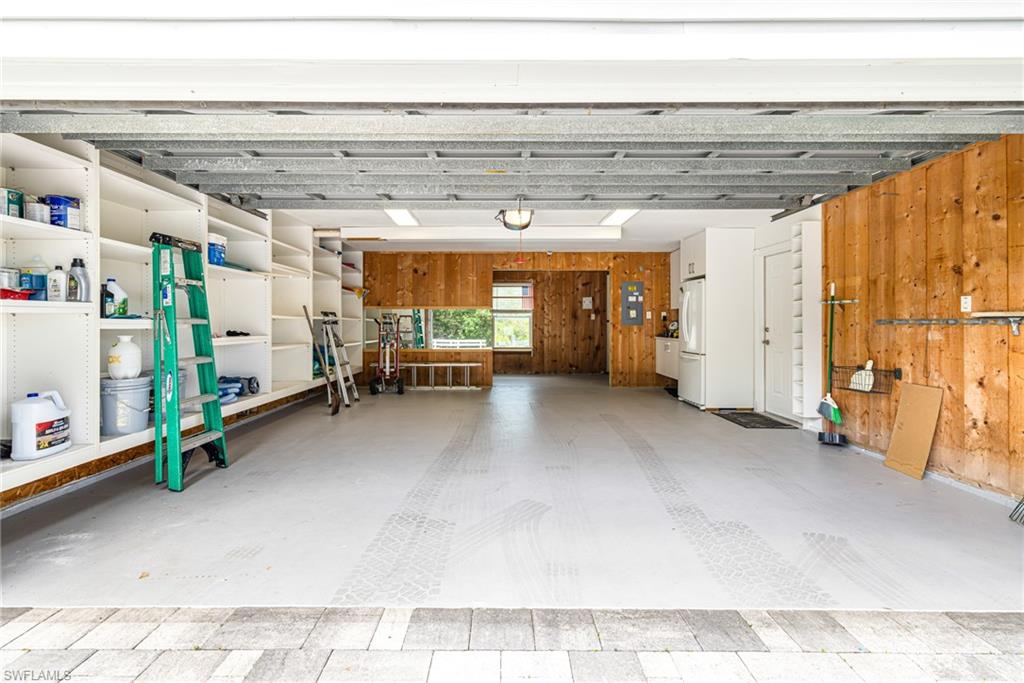 Integrated built-in shelving, durable light-colored flooring, wood-paneled walls, and a recessed window