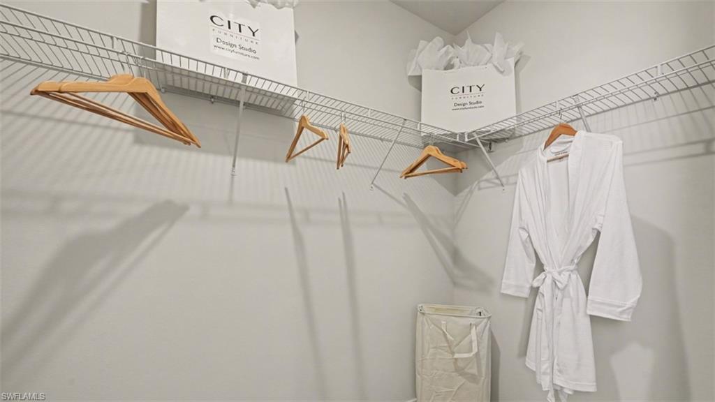 White interior featuring L-shaped wire shelving and hanging rods