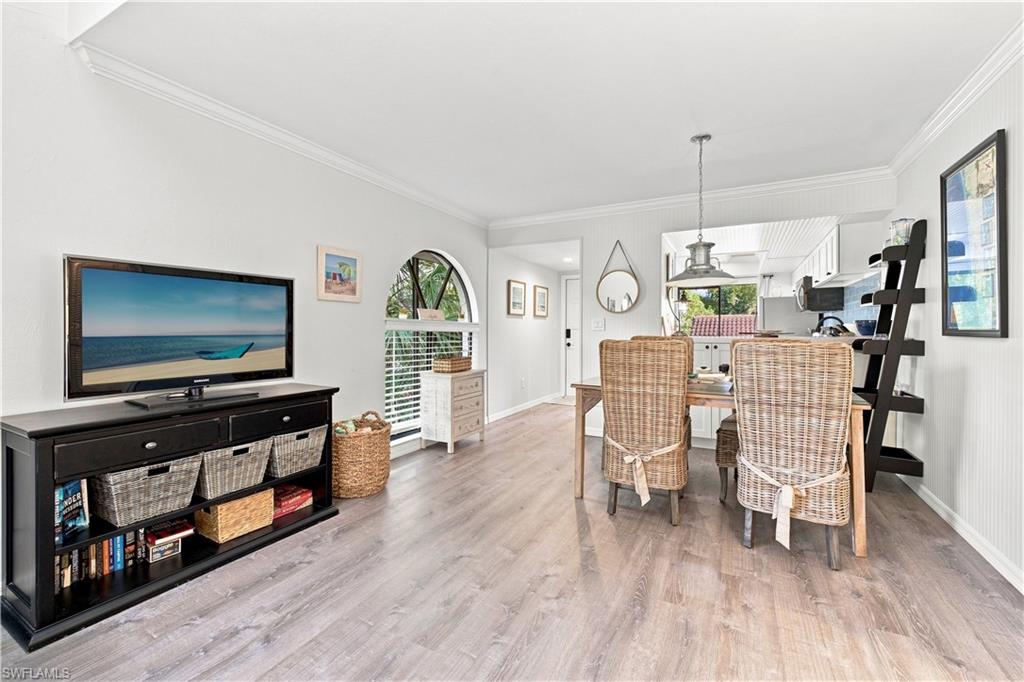 Crown molding accents the ceiling, above wood-finish flooring